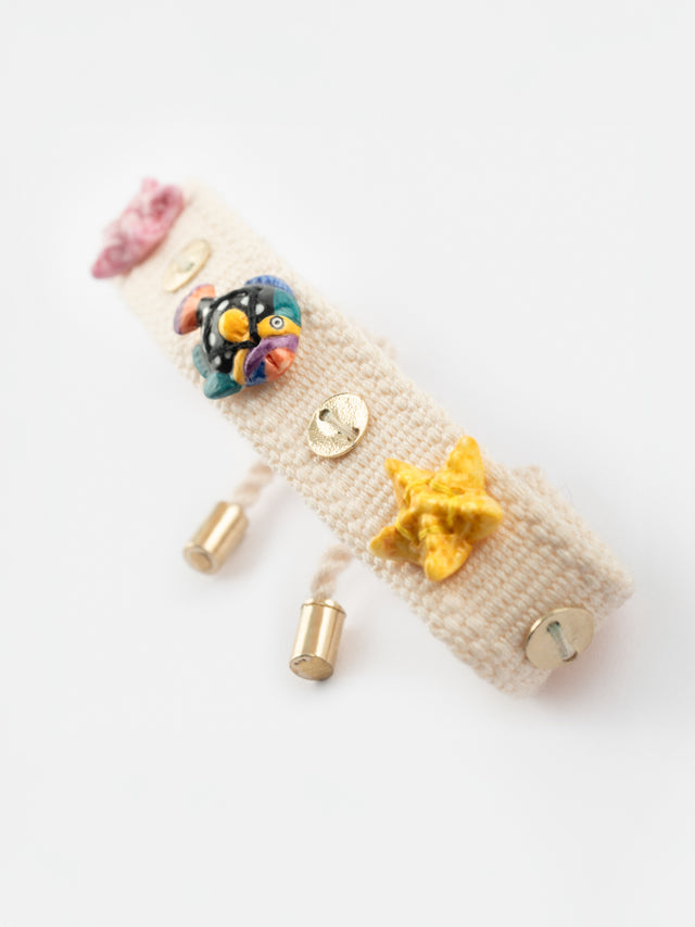 nach bijoux Bracelet tressé beige à charms